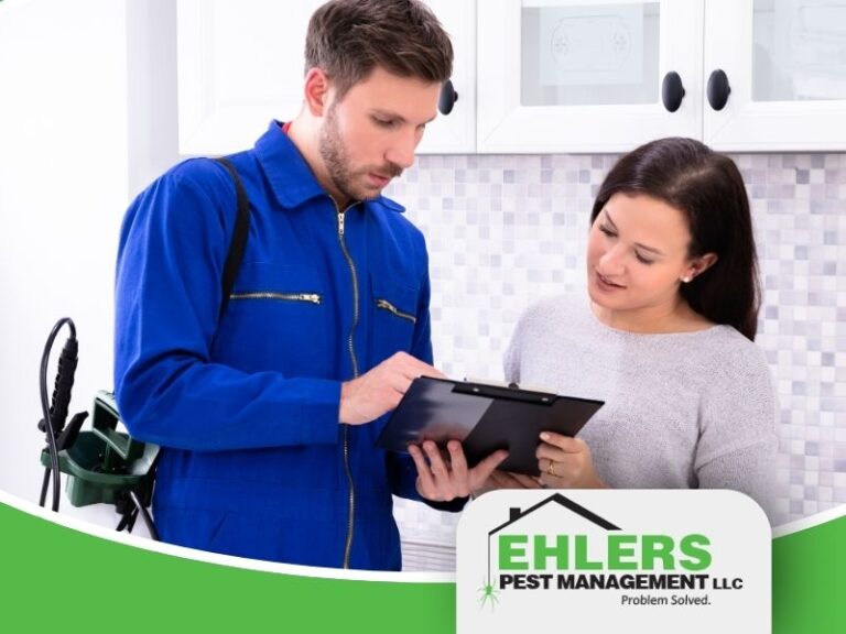 A pest control technician discusses Integrated Pest Management with a Wisconsin homeowner.