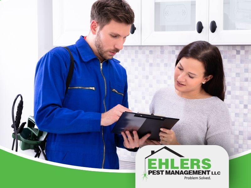 A pest control technician discusses Integrated Pest Management with a Wisconsin homeowner.