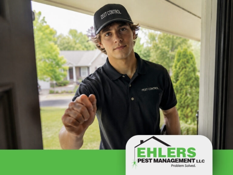 A young man in a Pest Control uniform knocks on a door, embodying professionalism and reliability—key qualities to look for when learning how to choose a pest control company. The Ehlers Pest Management LLC logo is displayed at the bottom of the image, with trees and houses visible in the background.